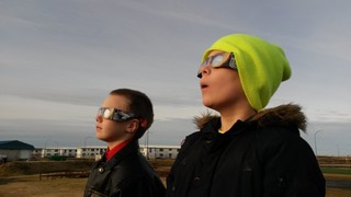 Two boys watch the solar eclipse in Iceland