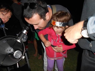 Parents and children view the night sky